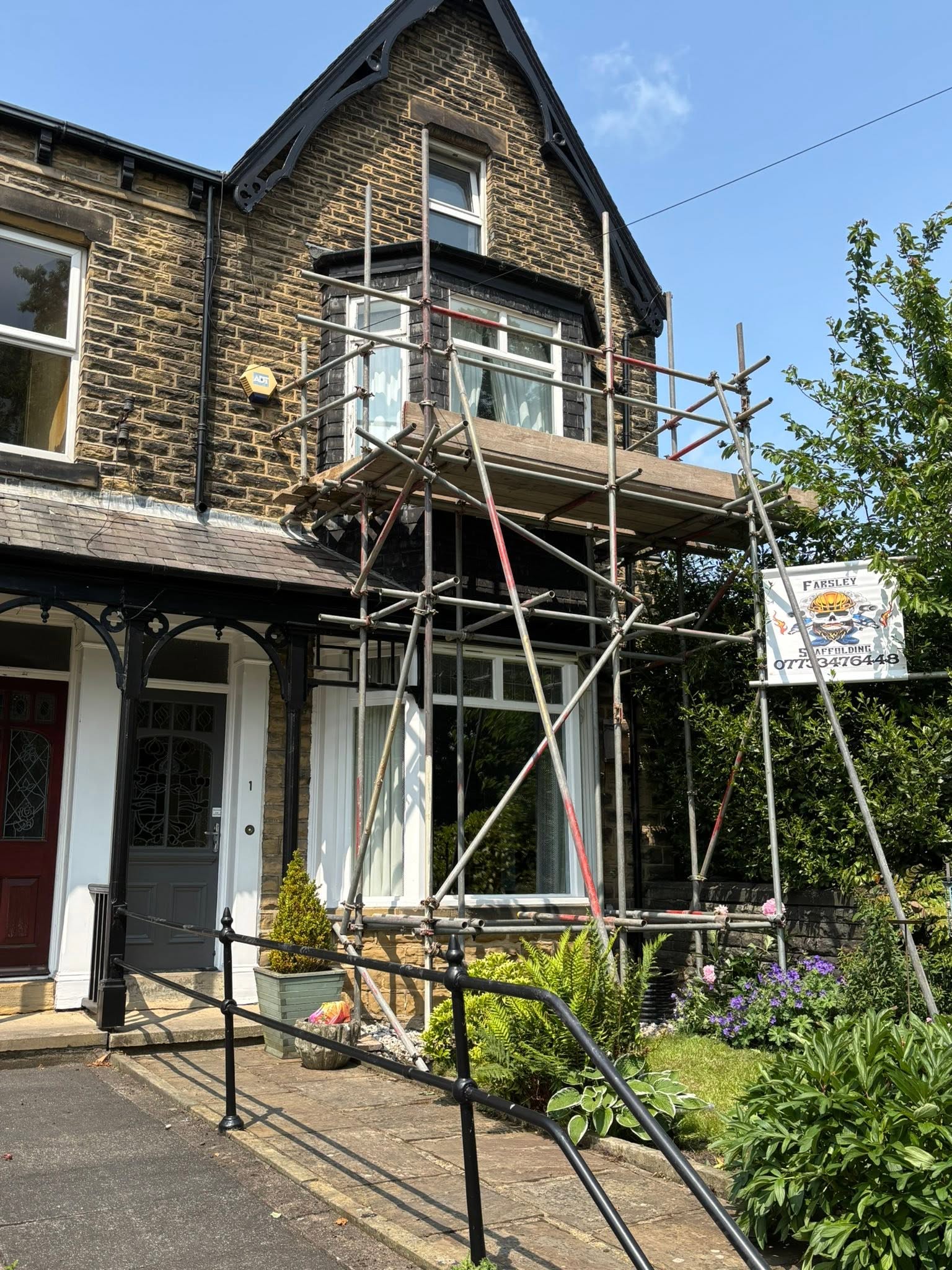 Scaffold built out from a bay window on a Leeds property