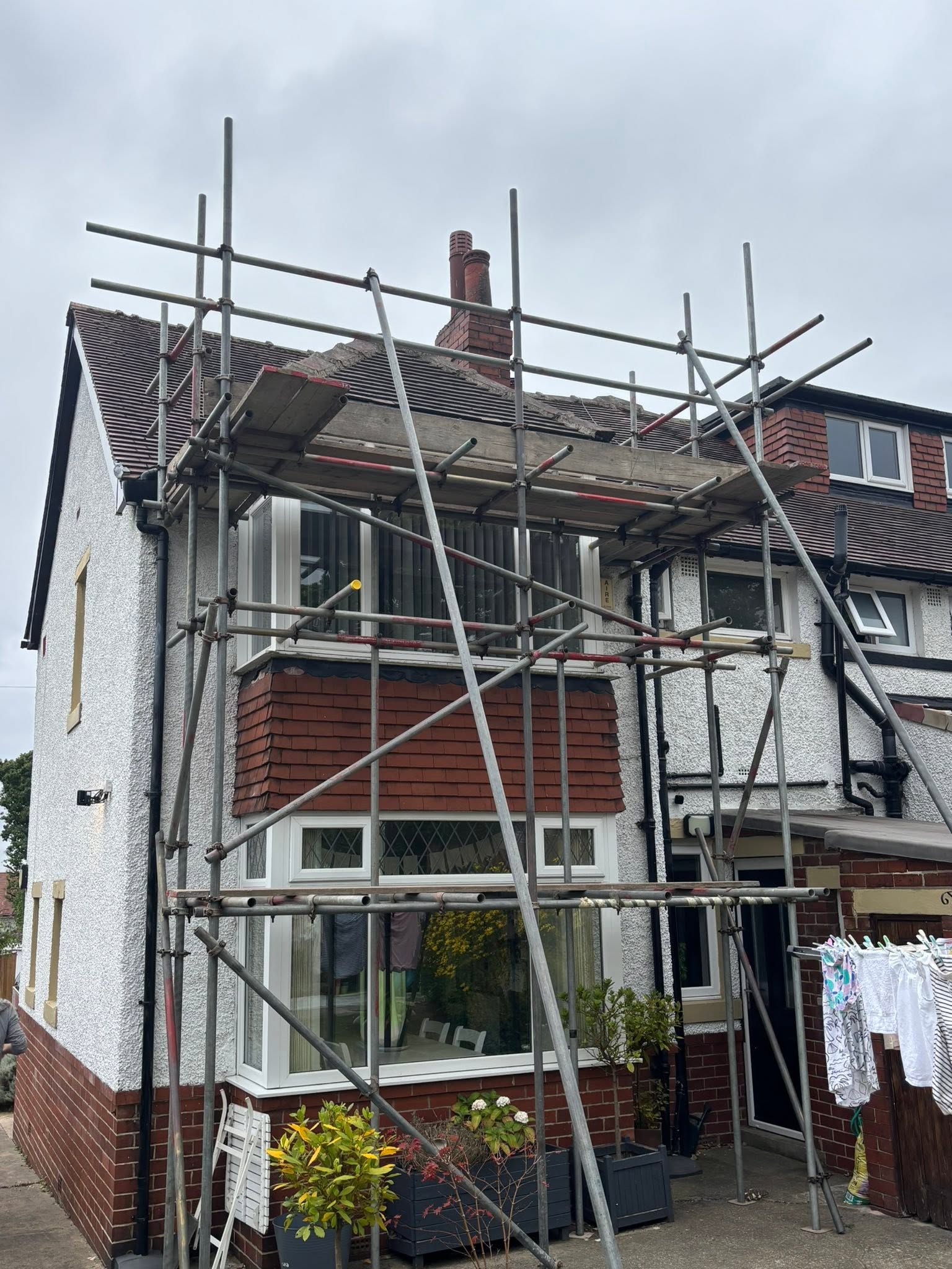 Scaffold erected across the front of a house in Leeds for maintenance access